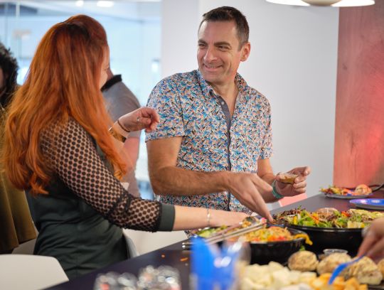 two employees talking at TIBO office lunch